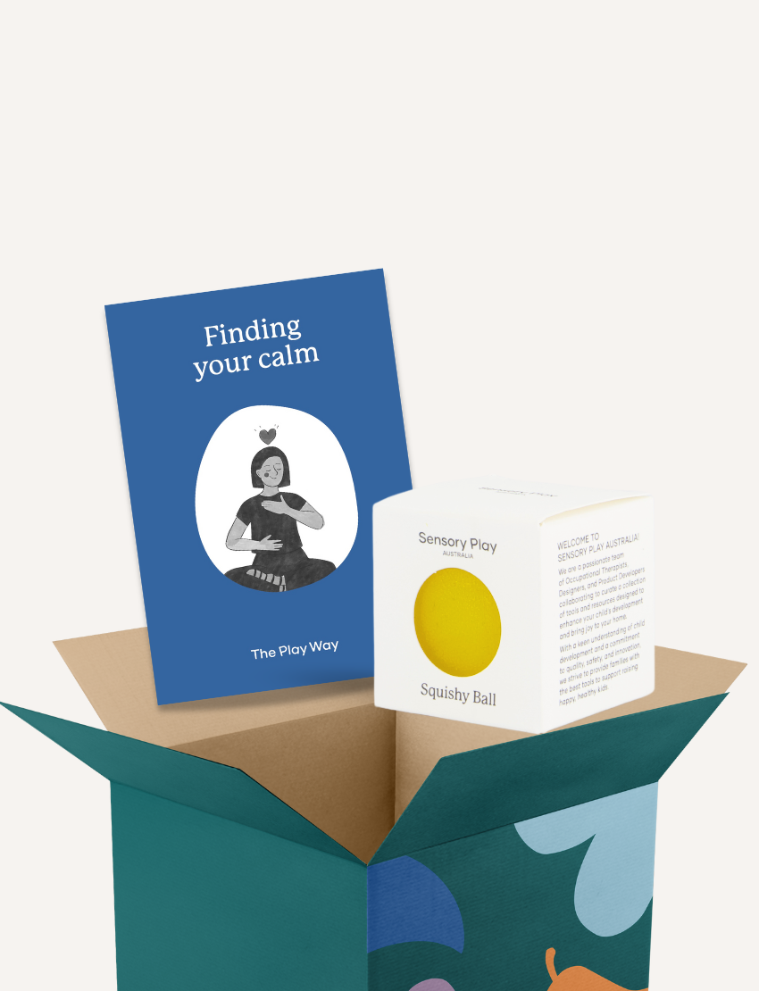 The image shows a teal box with its flaps open, containing a blue booklet titled "Finding your calm," a white box labeled "Sensory Play Squishy Ball," and a yellow squishy ball partially protruding from the box. This Calm Story and Squishy Ball Kit by The Play Way is perfect for sensory soothing and emotional regulation.