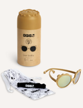 Two pairs of Ki ET LA's LION sunglasses for 2-4-year-olds are displayed. One, made in France, has dark frames with blue-tinted lenses; the other features light yellow frames with gold-tinted lenses. Both have round, unbreakable lenses and decorative frame accents.