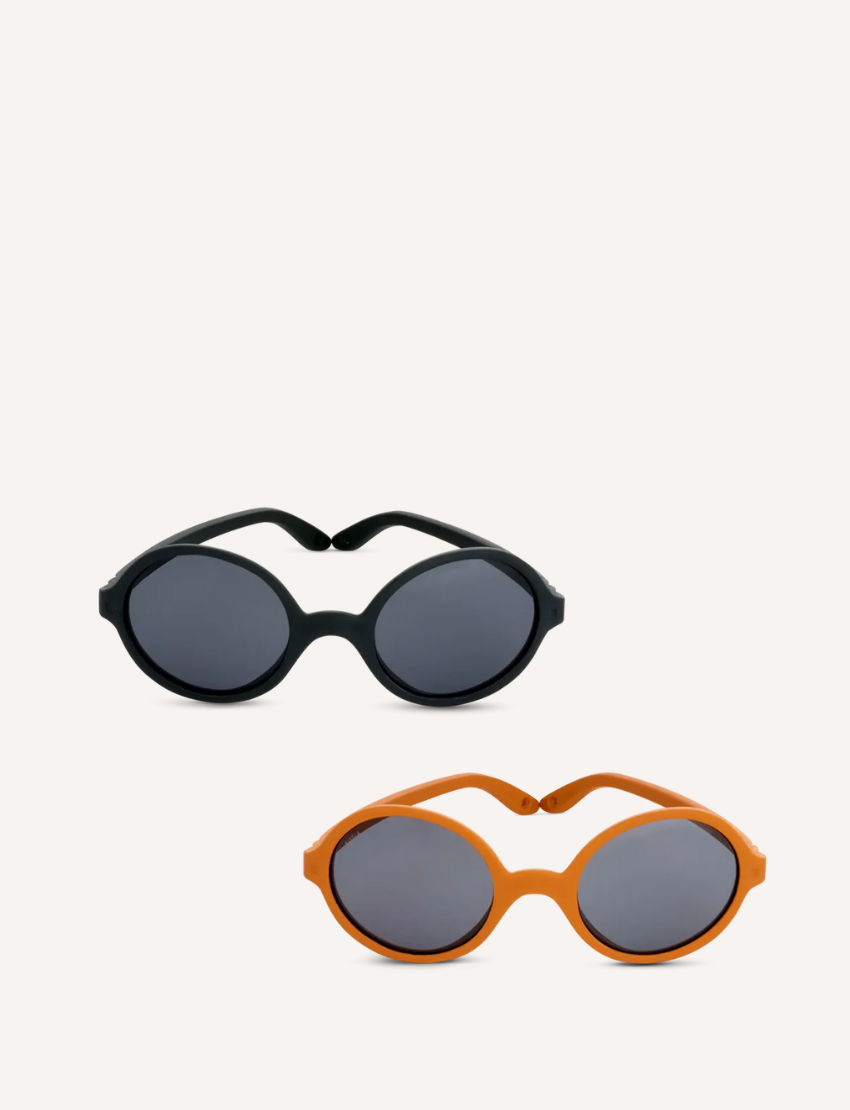 Two pairs of round sunglasses are shown against a plain backdrop. The top pair offers unbreakable frames with polarised lenses for durability, and the bottom pair features vibrant orange frames with dark lenses, ideal for children aged 2-4 years old. Brand: Ki ET LA, Product: ROZZ Sunglasses.