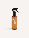 A 125 mL bottle of Melo Magnesium Sleep Spray with a black spray top. The label is orange with text that reads 