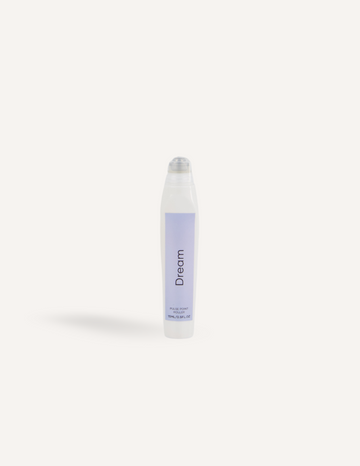 A white cylindrical container with a clear, slightly rounded cap, labeled "Melo Pulse Point Roller – Dream" in black text on a lavender-colored section. The text "10ml / 0.34 fl.oz" appears in small print at the bottom of the lavender section, perfect for your bedtime ritual and relaxation as an oil roller from the Melo brand.