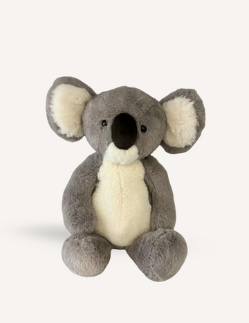 The Weighted Koala with Heart Beat from Sensory Play Australia is a plush toy featuring grey fur and large floppy ears. Designed to offer emotional comfort, this adorable koala has a white belly and inner ears, complemented by a black nose and black eyes. The koala is depicted sitting upright against a plain white background, making it perfect for sensory regulation needs.