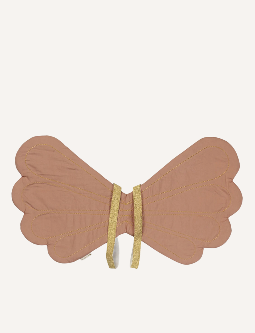 The Fairy Wings - Old Rose by Fabelab are a pair of fairy-inspired fabric wings crafted from organic cotton. These light brown wings feature scalloped edges and are secured with gold straps.