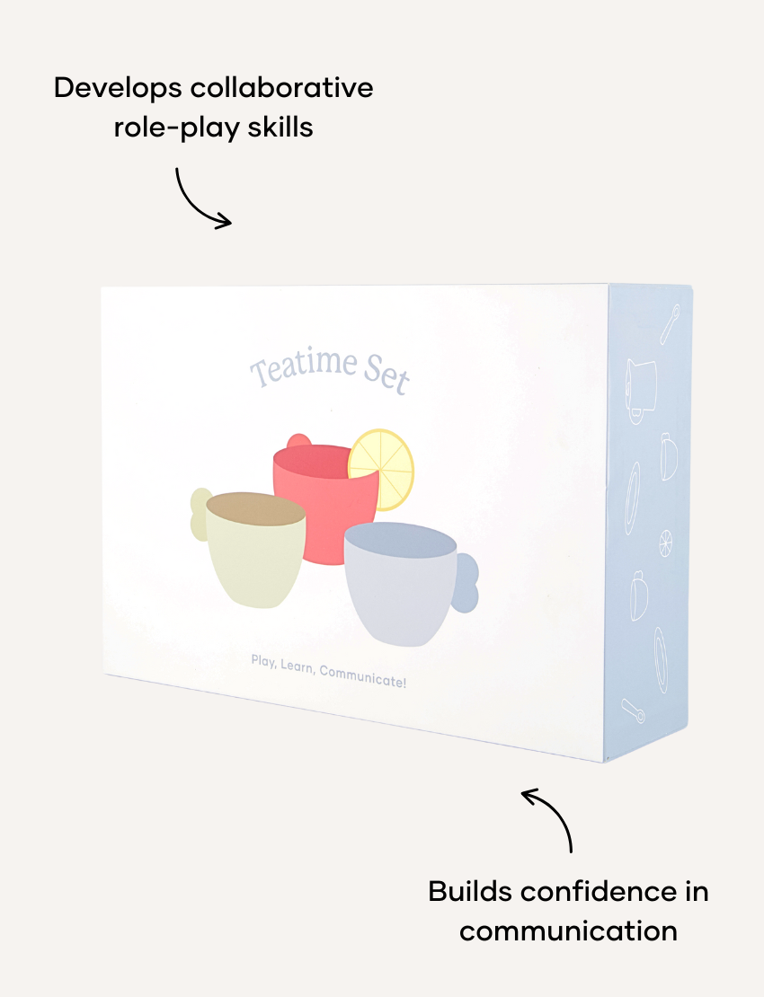 A child indulges in imaginative play with Sensory Play Australia's wooden Teatime Set, featuring a tray, three cups, a teapot, and spoons. Nearby is a metal sink with a draining area on the countertop to enhance cognitive skills through interactive fun.