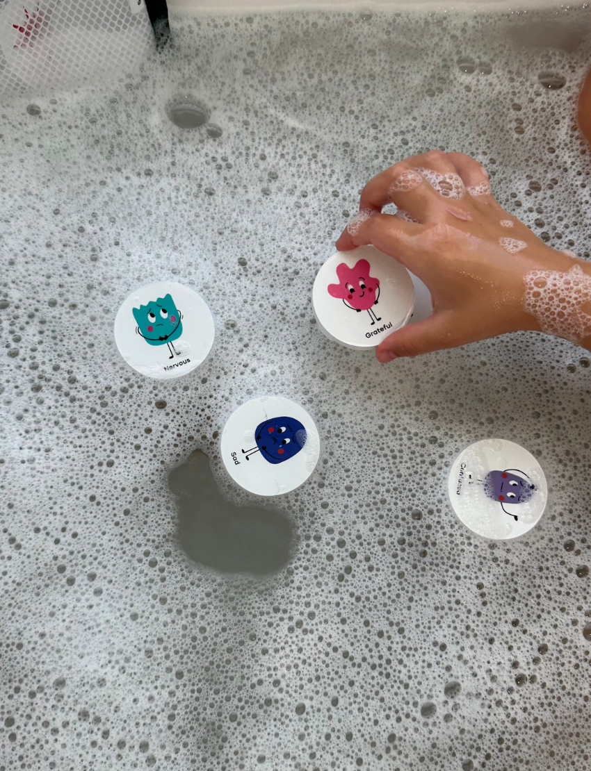 The "Bath Memory: Emotions" package by Sensory Play Australia offers fun learning. The blue packaging, adorned with colorful cartoon faces, contains 24 pieces that stick to the tub and tiles when wet, making emotions bath time both enjoyable and educational.