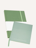 Three open Belucci journals with green covers are displayed. The nearest book, the Balance Journal & Guidebook, features a leaf illustration and the word 