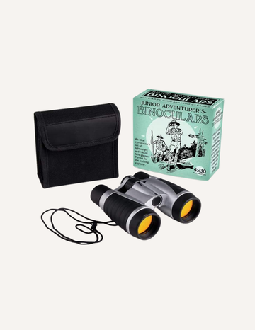 A pair of black and silver binoculars with yellow lenses from House of Marbles, accompanied by a black carrying case and a box labeled "Junior Adventurer's Binoculars." The binoculars have an attached neck strap.