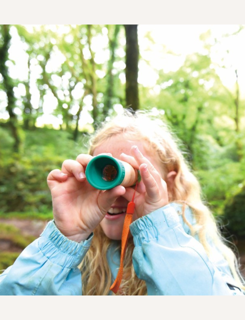 A compact, vibrant Hape Adjustable Telescope with a wooden body, green ends, and a bright orange strap lies against a plain white background.