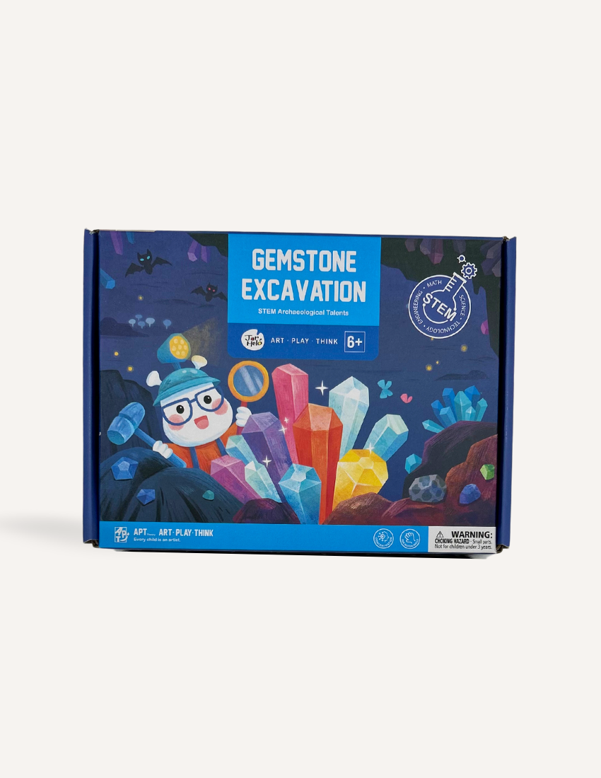 The image depicts a "Gemstone Excavation" STEM Archaeologist Kit by Jar Melo, intended for children aged 6 and older. The box showcases vibrant illustrations of a character unearthing various gemstones. It emphasizes "art, play, think" on the packaging and includes a safety warning.