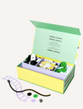 Experience the 3 in 1 Game Set by Journey of Something, featuring a chess and checkers set with black and white magnetic pieces adorned with faces. It comes with a green and white checkered box, a black carrying pouch, as well as flat round and cross-shaped pieces. The set also includes green coins and various square tiles for enhanced gameplay.