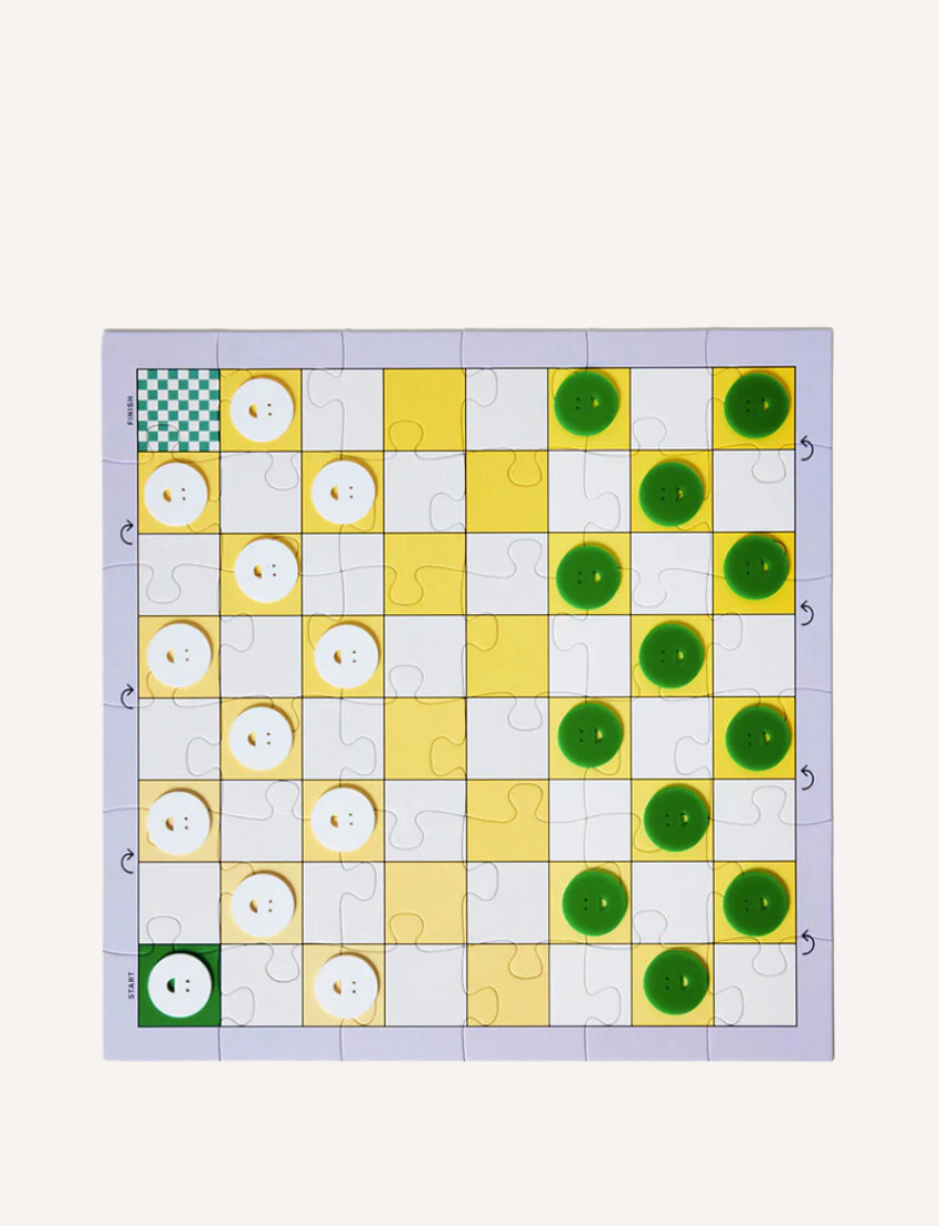 Experience the 3 in 1 Game Set by Journey of Something, featuring a chess and checkers set with black and white magnetic pieces adorned with faces. It comes with a green and white checkered box, a black carrying pouch, as well as flat round and cross-shaped pieces. The set also includes green coins and various square tiles for enhanced gameplay.