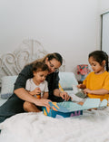 The Therapy At Home Sleep Program comes in a teal and green abstract box filled with a plush koala, children’s sleep books, white eye mask, mini fan, lotion, journal, markers, and cards.