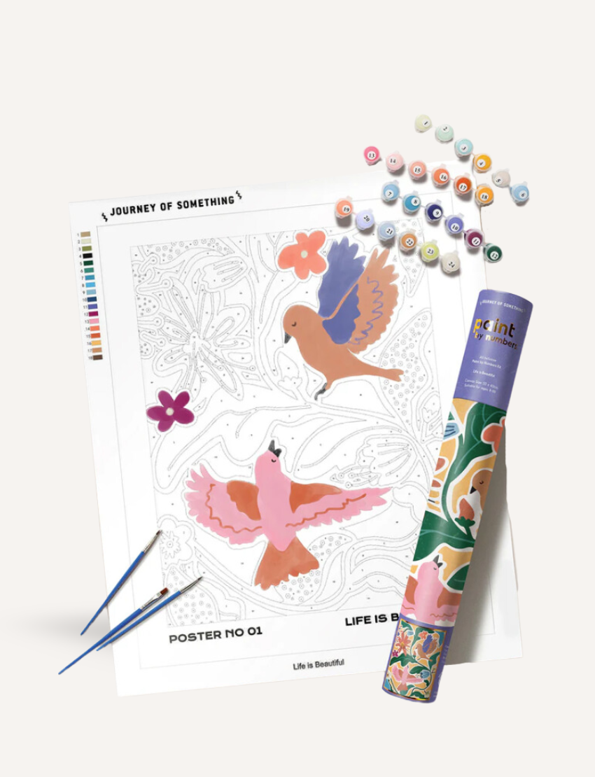 Explore mindfulness with our Paint by Numbers kit by Journey of Something. Enjoy creating art with a canvas titled "Life is Beautiful," featuring two illustrated birds and flowers. Complete your masterpiece using 16 numbered paint pots and two brushes, all in a decorative tube.