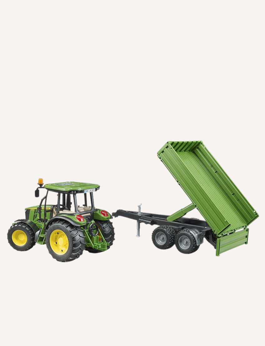 The Bruder John Deere Tractor with Tipping Trailer by Bruder is a compact toy green tractor featuring a yellow wheel trim, paired with a matching tandem-axle trailer. The trailer has two sets of wheels and an open cargo area, ideal for transporting loads during play. The setup is displayed against a plain white background.