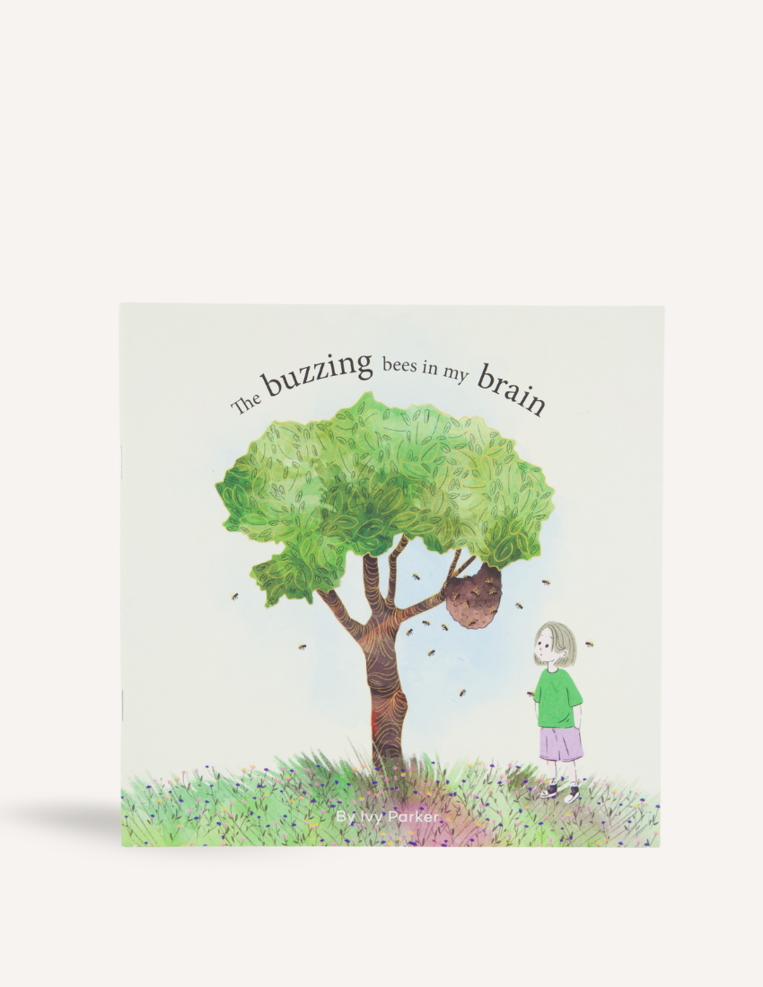 Cover of "The Buzzing Bees in My Brain Storybook" by Ivy Parker, a publication from The Play Way. The illustration features a girl standing near a tree with a beehive, encircled by bees. She is depicted wearing a green shirt, purple pants, and red shoes, embodying the sense of being overwhelmed amidst the buzzing chaos. This storybook is ideal for providing tips to parents on handling meltdowns.