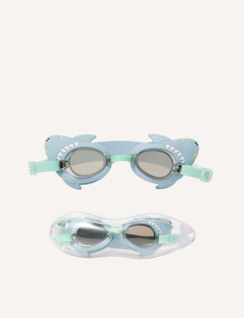 On a plain background, two pairs of Sunnylife's Mini Swim Goggles are displayed. The top pair is pink adorned with a shell design, while the bottom pair is blue with intricate shark details, including fins and teeth.