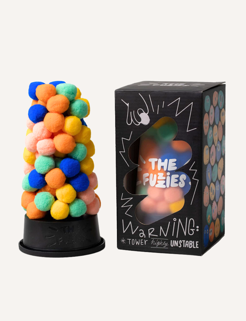 A vertical arrangement of small, colorful pom-poms from The Fuzzies Game by VR Distribution stands on a black base, featuring vibrant hues such as blue, green, orange, pink, and yellow.