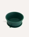 An open green and teal cardboard box from The Play Way's Tools For Eating - Bowls & Plates Kit contains a set of stackable silicone suction bowls, a set of stackable cups, and an upright blue divided baby plate. The items are neatly arranged, showcasing their self-feeding design.