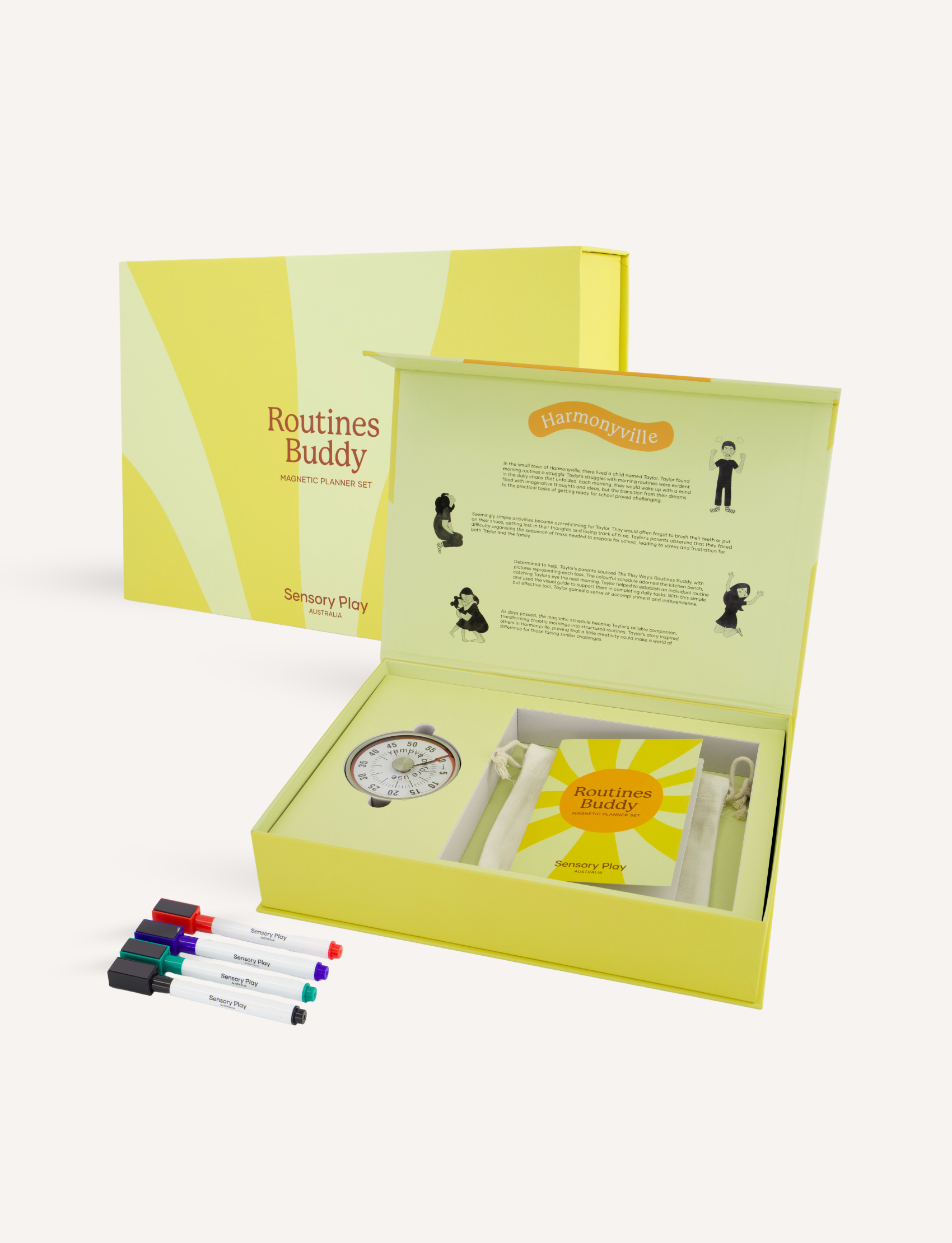 A yellow box labeled "Routines Buddy" from Sensory Play Australia contains various items, including colorful markers, a booklet, a circular timer, and an assortment of printed cards with images. Nearby are a phone and a tablet displaying related content. A weekly planner and stickers are also visible.