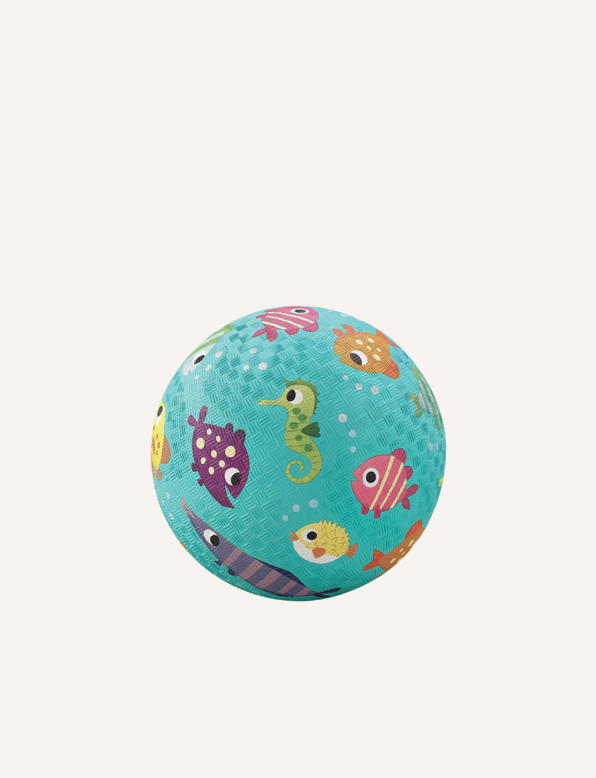 The Crocodile Creek 5 Inch Playground Ball is a yellow rubber ball with a textured surface adorned with vibrant illustrations of construction vehicles, including diggers and trucks, set against a simple light-colored background.