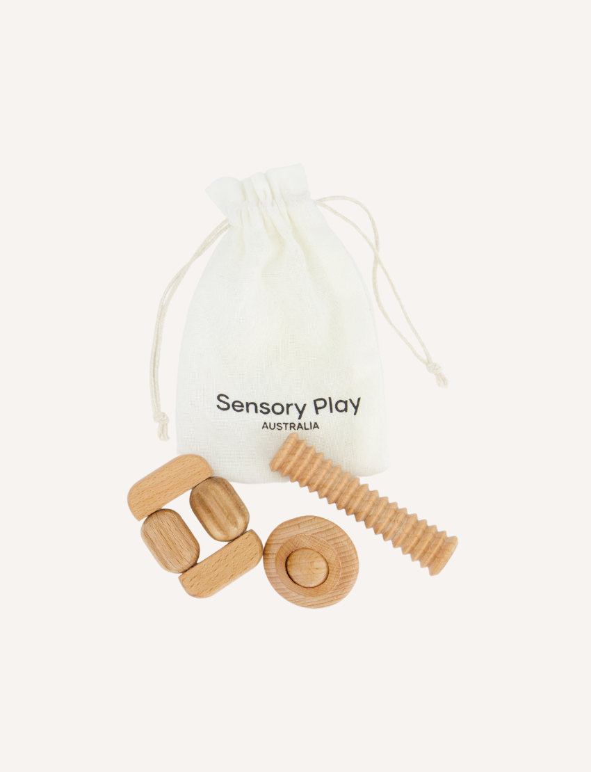 The Regulation and Reflection Kit by The Play Way contains various educational and sensory items. Visible items include a book titled "STIMS, SCHOOL & ME," breathing cards, a mini MP3 player, reflective journal cards, a sensory play kit, and a book titled "The Buzzing Busy Brain.