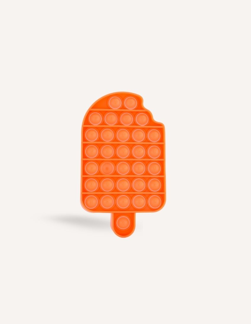 The Preppit Pop It is an orange, ice-cream shaped sensory toy featuring evenly spaced bubble-like buttons. Designed with a small bite-shaped notch at the top left corner and a flat bottom with a short stick-like handle, this toy is ideal for sensory regulation or as a distraction during mealtime. The background is plain white.