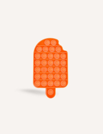 The Preppit Pop It is an orange, ice-cream shaped sensory toy featuring evenly spaced bubble-like buttons. Designed with a small bite-shaped notch at the top left corner and a flat bottom with a short stick-like handle, this toy is ideal for sensory regulation or as a distraction during mealtime. The background is plain white.