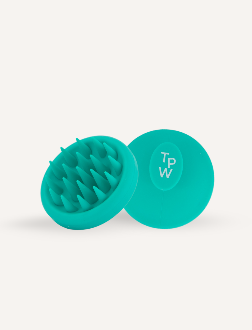 A teal Sensory Play Australia Scalp Therapy Massager featuring multiple rubber bristles is displayed beside its blue product box. The box contains usage tips and safety information, making it an essential addition to your hair care routine for a healthy scalp.