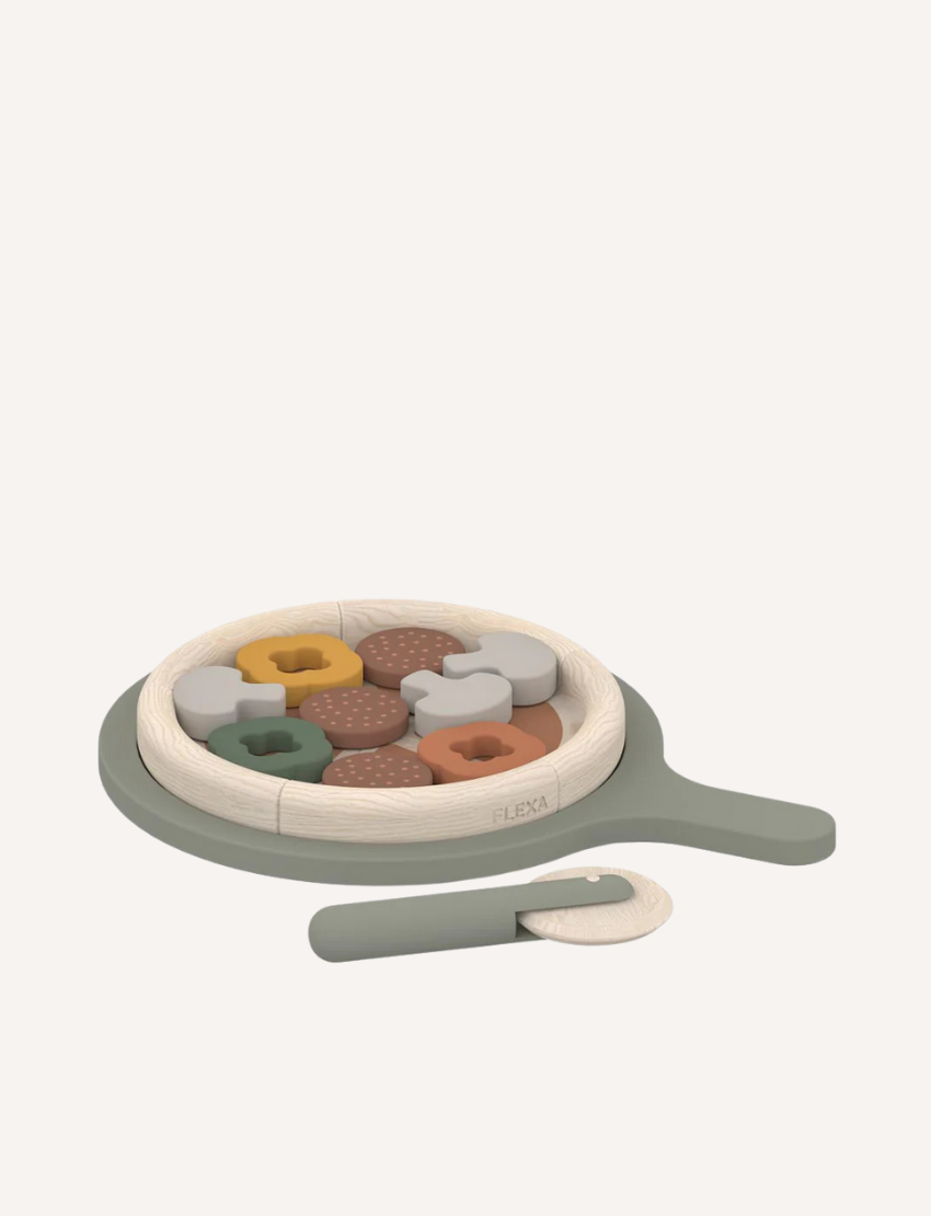 Wooden pretend play pizza set featuring a sage green pizza peel, multi-colored sliceable toppings, and a matching wooden pizza cutter.
