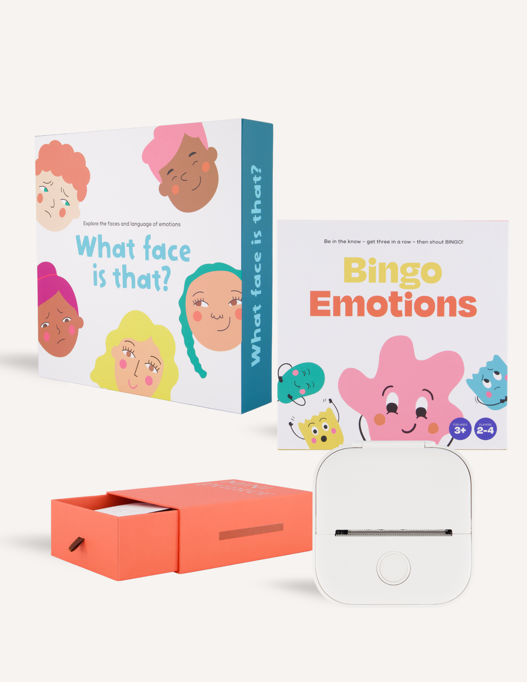 The image shows "Emotional Literacy Package" by The Play Way, a children's game set with cartoon faces and "Bingo Emotions" cards. It's designed to enhance early literacy skills and comes in an orange drawer-style box with a white device, making learning enjoyable.