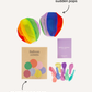 A set of colorful balloon covers by Sensory Play Australia, featuring an inflated beach ball, several deflated balloons in various colors, and a cardboard box labeled "Balloon Covers" with balloon illustrations.