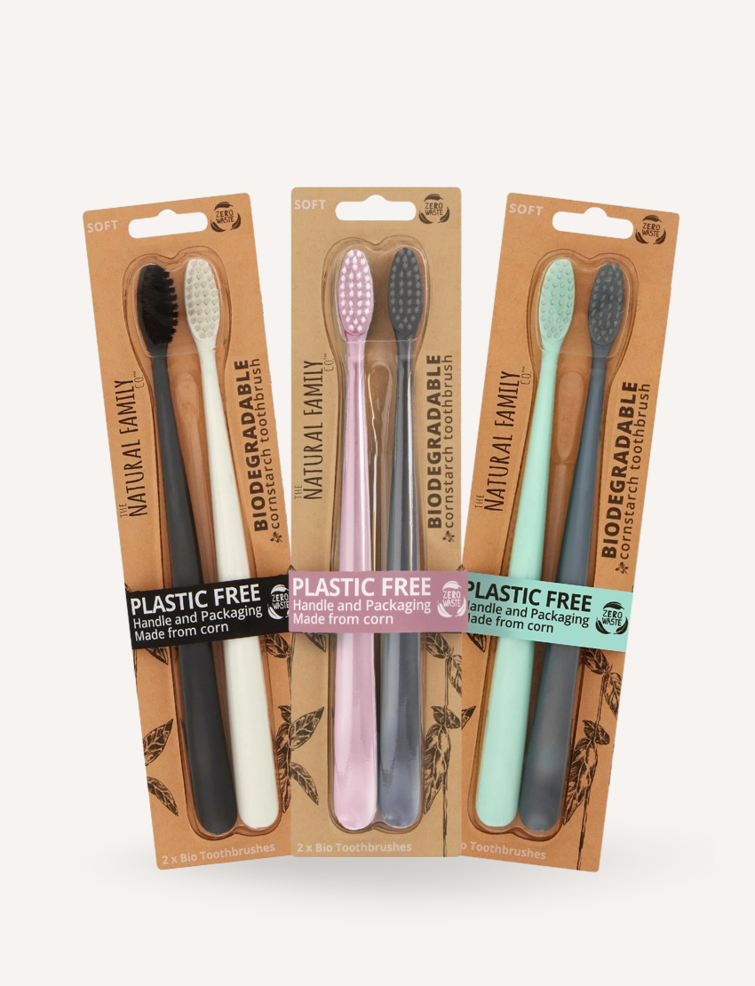 The Natural Family Biodegradable Cornstarch Toothbrushes: Mint/Grey, Pink/Grey, Black/White twin packs.