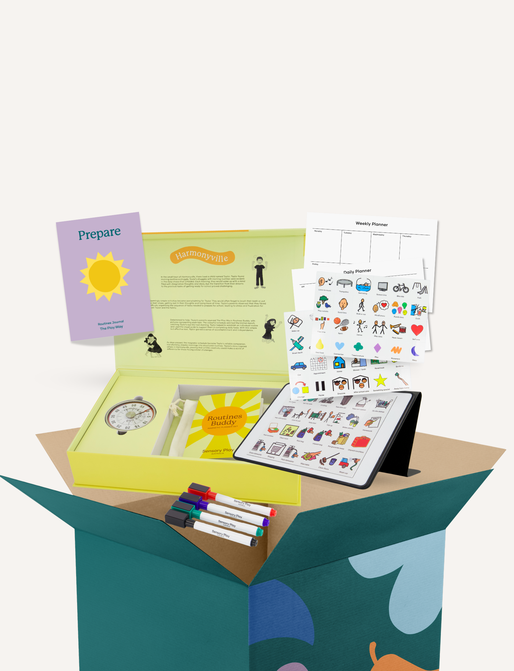 A yellow box labeled "Routines Buddy" from Sensory Play Australia contains various items, including colorful markers, a booklet, a circular timer, and an assortment of printed cards with images. Nearby are a phone and a tablet displaying related content. A weekly planner and stickers are also visible.