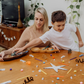 The Creative Mindfulness: Mandalas Program by The Play Way includes a vibrant open box with markers, colored pencils, notebooks, paint, a tote bag, and crafting materials. It has abstract green, purple, and orange patterns with "The Play Way" text.