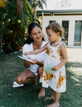 The Early Years Language Program by Therapy At Home features an open teal box neatly filled with educational toys, animal figurines, wooden blocks, a toy tea set, illustrated cards, books, and activity sheets for play-based learning and language development.