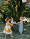 The Early Years Language Program by Therapy At Home features an open teal box neatly filled with educational toys, animal figurines, wooden blocks, a toy tea set, illustrated cards, books, and activity sheets for play-based learning and language development.