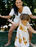 The Early Years Language Program by Therapy At Home features an open teal box neatly filled with educational toys, animal figurines, wooden blocks, a toy tea set, illustrated cards, books, and activity sheets for play-based learning and language development.