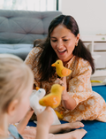 The Early Years Language Program by Therapy At Home features an open teal box neatly filled with educational toys, animal figurines, wooden blocks, a toy tea set, illustrated cards, books, and activity sheets for play-based learning and language development.