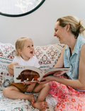 The Early Years Language Program by Therapy At Home features an open teal box neatly filled with educational toys, animal figurines, wooden blocks, a toy tea set, illustrated cards, books, and activity sheets for play-based learning and language development.