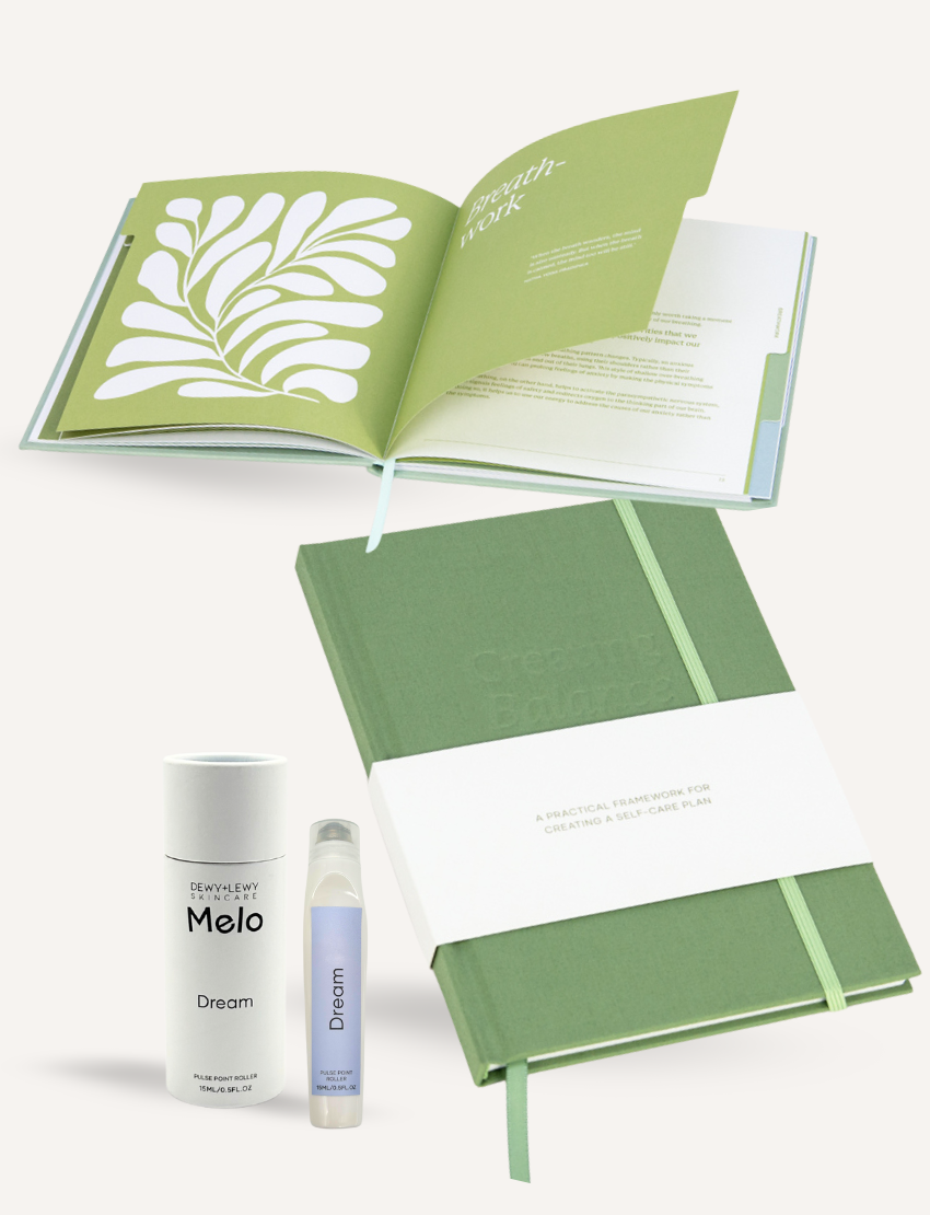 An open green workbook with a leaf design and text lies next to its closed counterpart, featuring an elastic band. Nearby are a Melo Dream cylindrical container and a Dream spray bottle, perfect self-care tools for emotional balance—all part of The Play Way's Educator Wellbeing Professional Development Package.