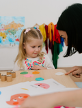 The Therapy At Home Emotions Part 1: Naming our Feelings Program comes in a teal and green box with colorful shapes, containing books, cards, charts, and activities to help children build emotional awareness and understand feelings.