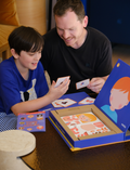 The Emotions Part 2: Discovering our Body's Clues Program by Therapy At Home features illustrated books, activity cards, stickers, educational sheets, and game pieces to help kids build body awareness and emotional regulation through fun play with anatomical cut-outs.