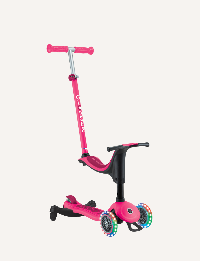 The Globber Go Up Sporty Lights 360 - Deep Pink is a versatile three-wheel children's scooter with an adjustable handlebar. It offers vibrant LED wheels and a seat attachment, making it ideal for young riders.