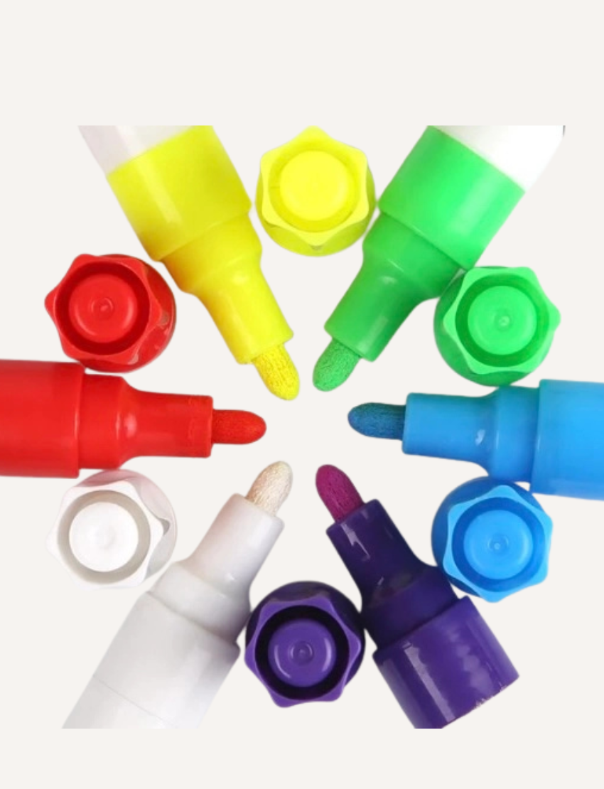 A box of liquid chalk markers from Jar Melo, labeled "Liquid Chalk Markers," comes in blue packaging adorned with playful illustrations of leaves and doodles. It promises "Easy Clean" functionality and is designed for children aged 3 and up. A warning label is also present on the bottom right corner.