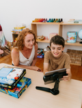 An open Therapy At Home Language Promotion Program box with playful green and teal designs reveals educational books, cards, and colorful language development activity materials neatly arranged inside.