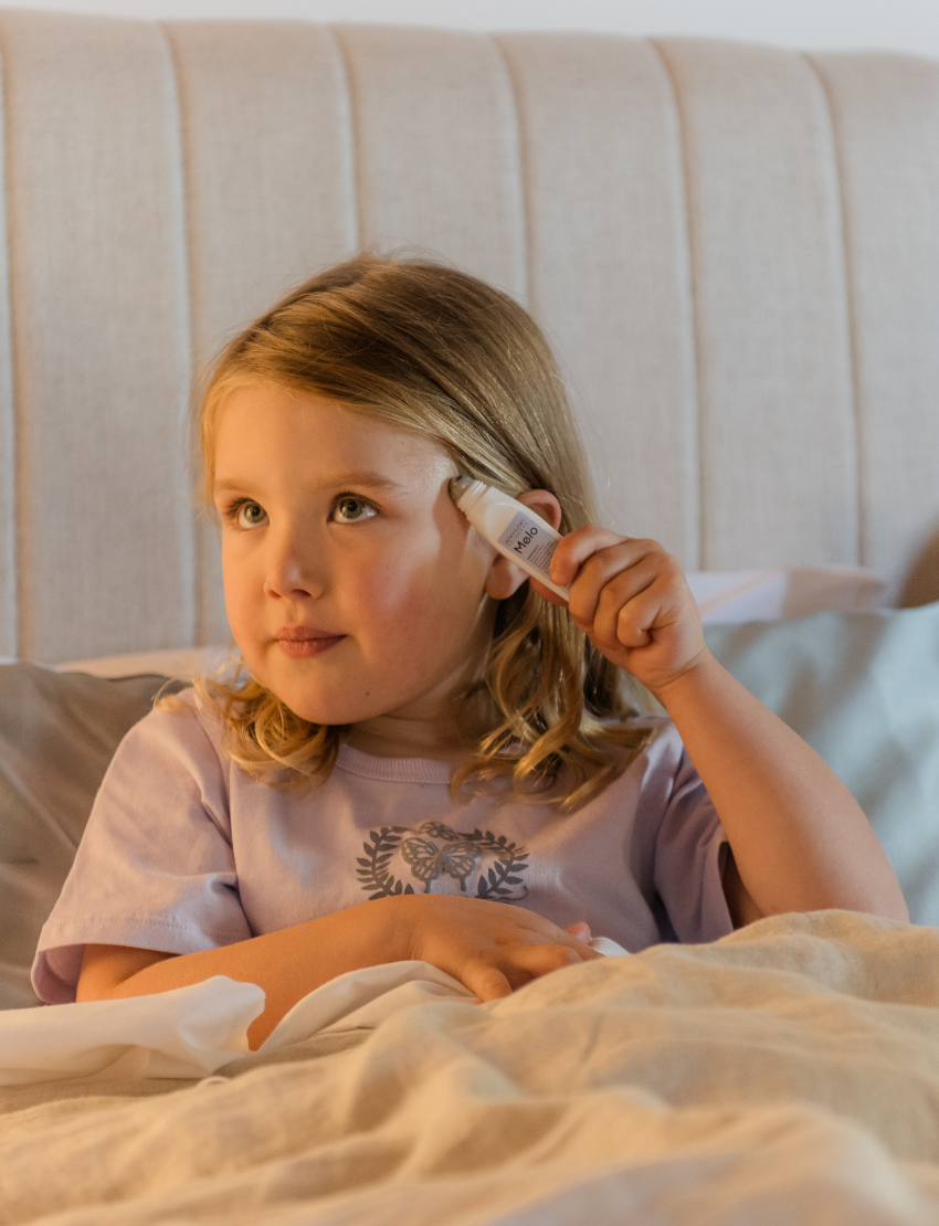 A round, light blue box labeled "Sensory Play Australia" contains the "Sleep Set," which includes a white cylindrical bottle labeled "Melo Dream," a brown spray bottle labeled "Melo," and a folded light blue fabric item, possibly an eye mask or pillowcase.