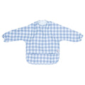 We Might Be Tiny Messie Smock Bib featuring long sleeves and a front pocket in a light blue and white gingham pattern.