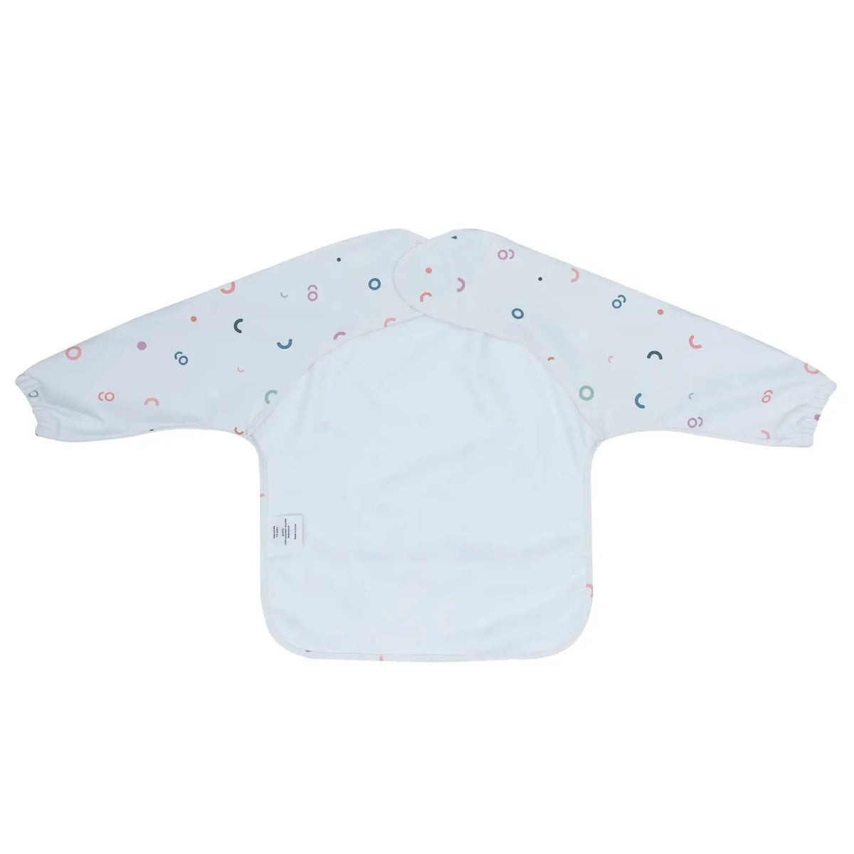 Messie Smock Bib featuring long sleeves and an all-over pattern of small multicolored shapes on a white background.