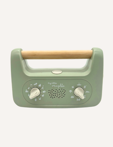 Sporting a soft green design and a wooden handle, the My Little Morphee Relaxation & Sleep Aid by Morphee features two dials and a speaker grille. The front showcases white illustrations along with the brand name "my little morphée," providing calming sounds for restful sleep.