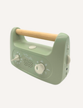 Sporting a soft green design and a wooden handle, the My Little Morphee Relaxation & Sleep Aid by Morphee features two dials and a speaker grille. The front showcases white illustrations along with the brand name 